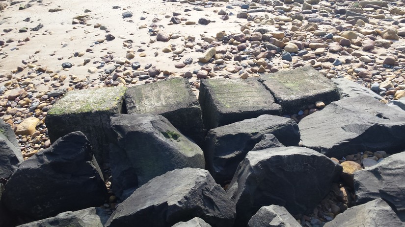 Anti-tank cubes at Beadnell protecting the harbour wall
