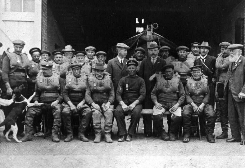 The crew of the Louisa Heartwell wearing the medals awarded after the rescue of the Fernebo. Henry Blogg sits in the centre
