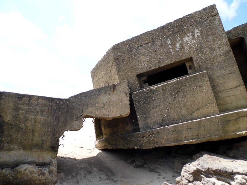 An eared pillbox which has slipped off the cliff and is butting an anti-tank wall