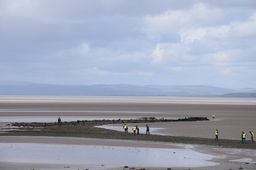 Volunteers brave blustery conditions to start work at the pier.