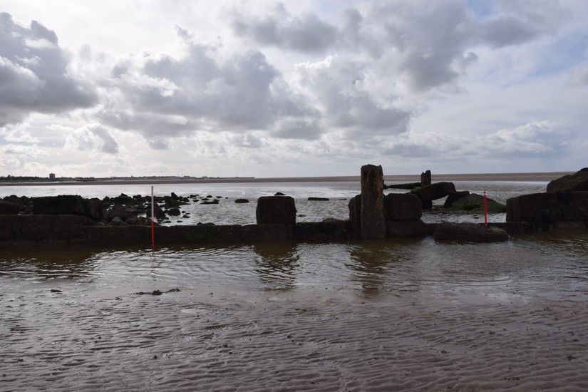 Extant timbers and what remains of the stone wall.