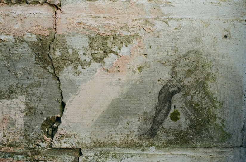 Female leg in a stocking, graffiti on a cell wall