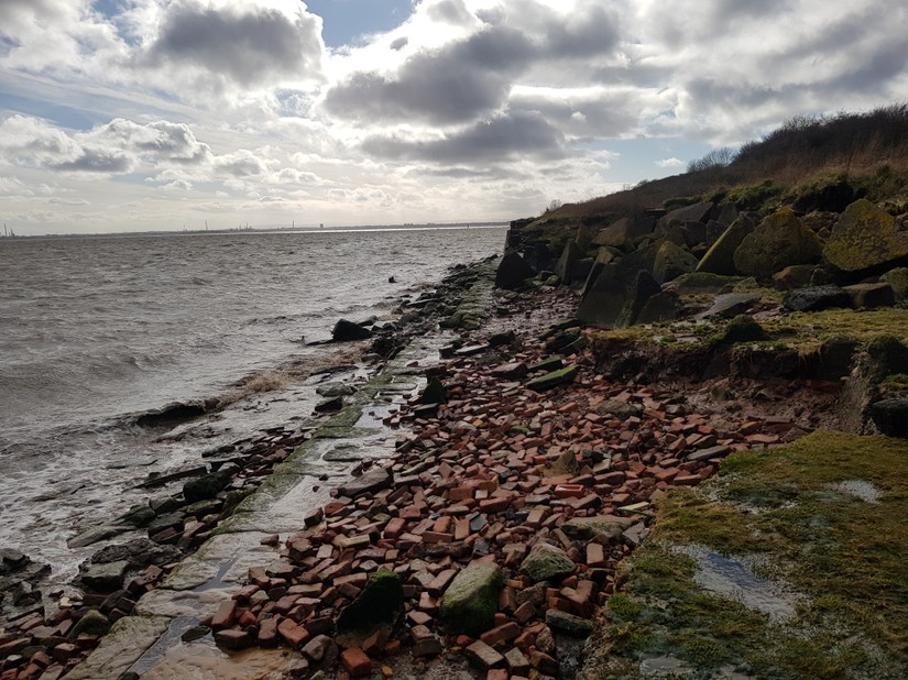 The remains of the Dungeon Saltwork's quay backed by demolition rubble